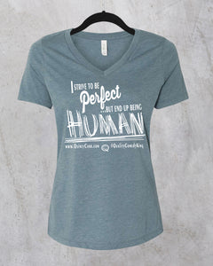 Teal v-neck t-shirt featuring the quote, “I strive to be perfect but end up being HUMAN,” emphasizing authenticity and imperfection.